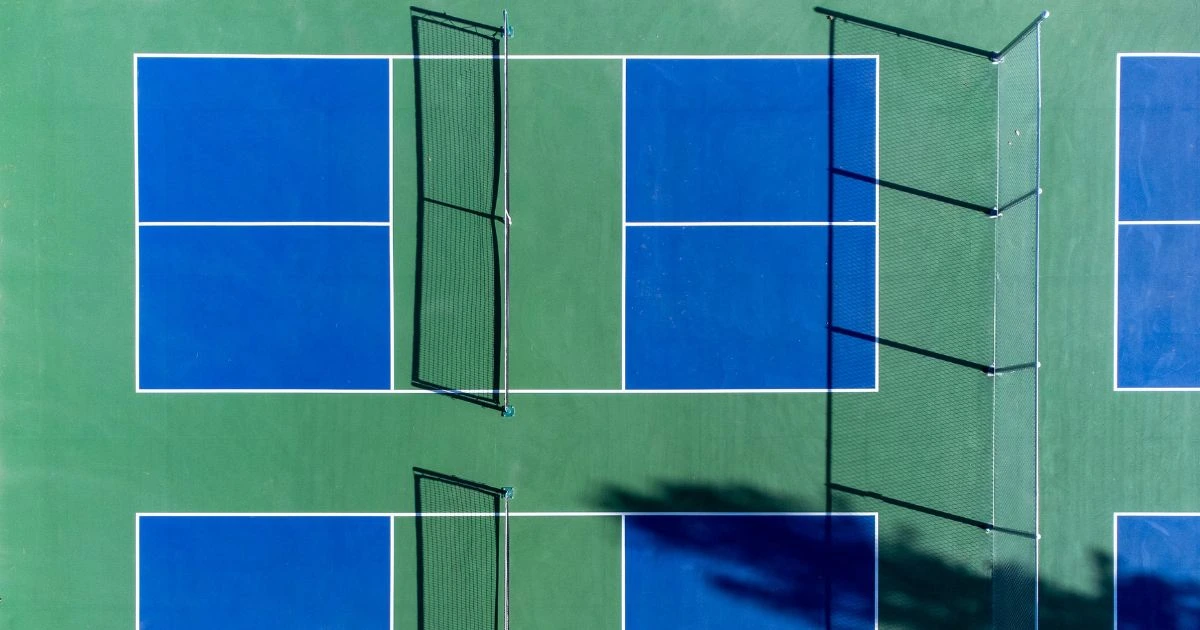 Pickleball court dimensions illustrated, showing standard layout with precise measurements for singles and doubles play, including non-volley zones and net height details.